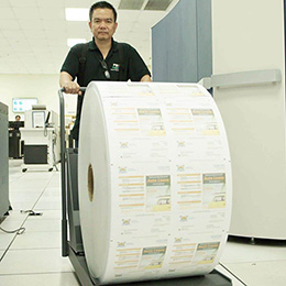 employee rolling huge roll of printed statements