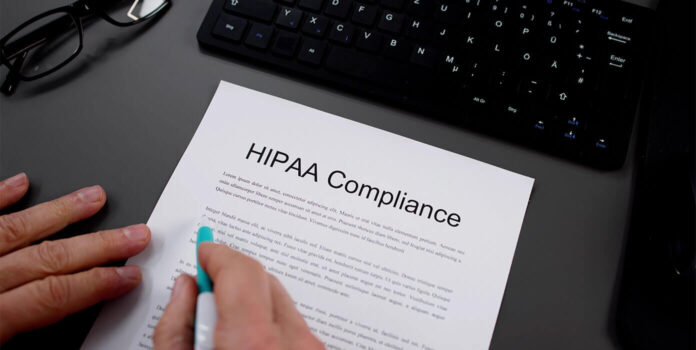 Person looking at a document that says hipaa compliance