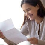 Image: Girl opening and reading a donation letter request