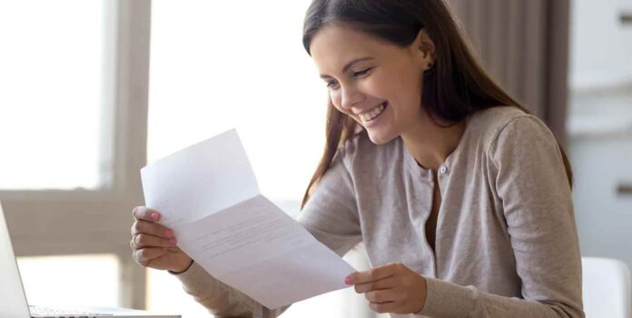 Girl opening and reading a donation letter request