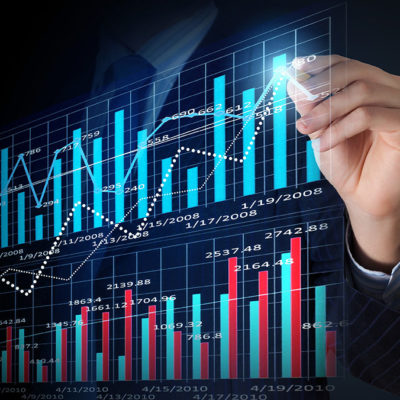 Image: a person drawing over marketing charts