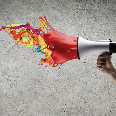 Image: a megaphone with paint splashing out of it