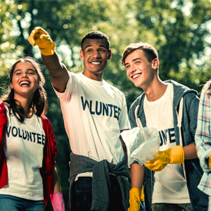 elevated direct mail fundraising Group of people working for a non-profit organization wearing same white shirt with the word volunteer on it
