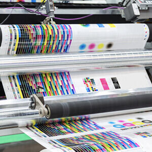 commercial printing equipment with color swatches being printed.